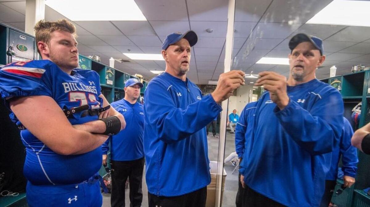 Folsom coach Kris Richardson draws up a play on the mirror inside the locker room before the Bulldogs’ Sac-Joaquin Section Division I championship game against the St. Mary's Rams at Sacramento State on Saturday.