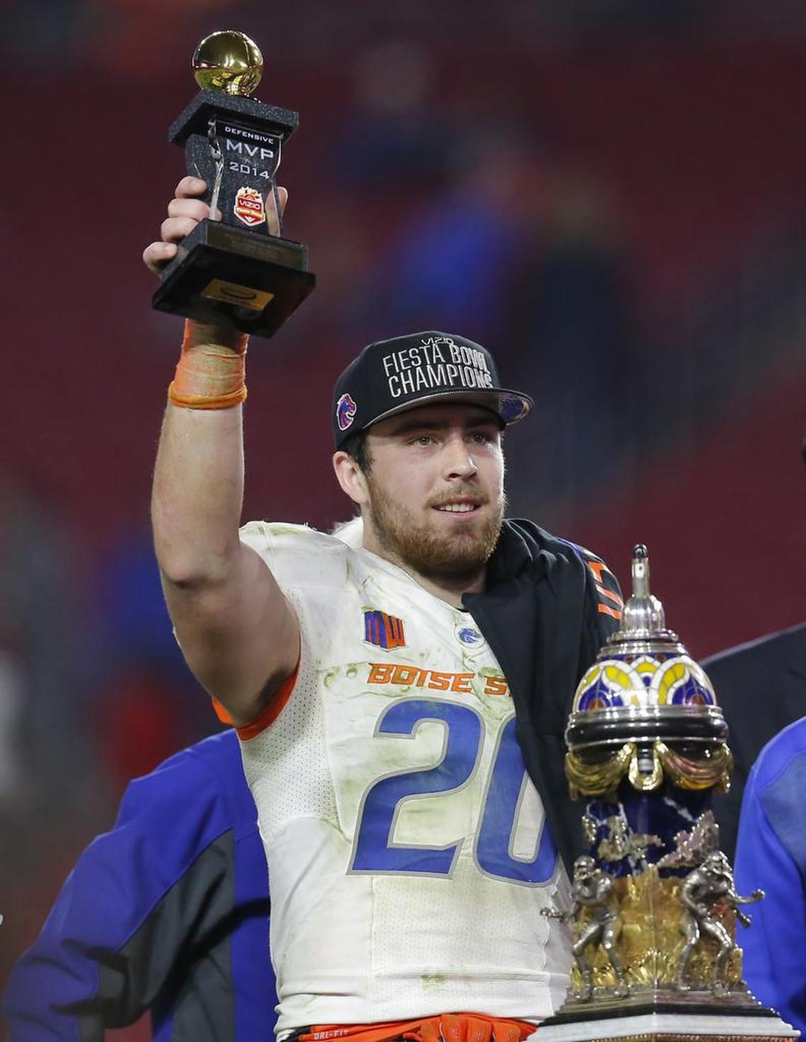 Boise State linebacker Tanner Vallejo hold the game defensive MVP trophy the Fiesta Bowl NCAA college football game, Wednesday, Dec. 31, 2014, in Glendale, Ariz.