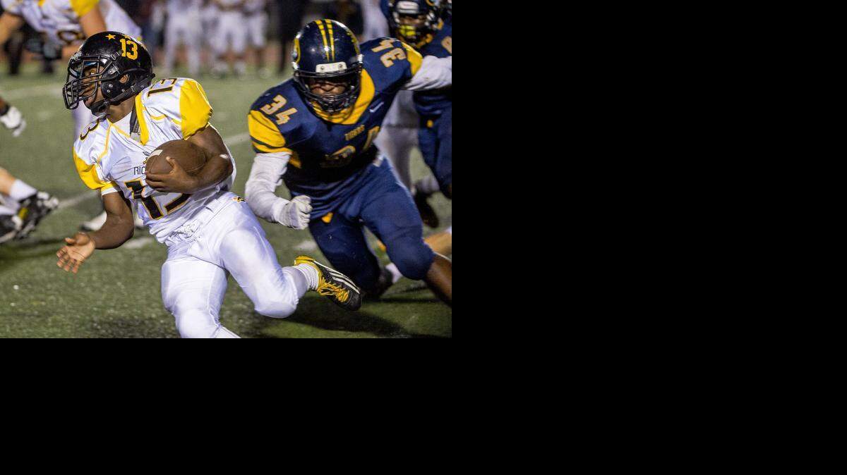
Rio Linda High School’s Calvin Robinson (13) runs with the ball as Inderkum High School’s Ryan Gatoloai-faupula (34) chases him during the first quarter as the Inderkum Tigers host the Rio Linda Knights football team on Friday, October 31, 2014.
