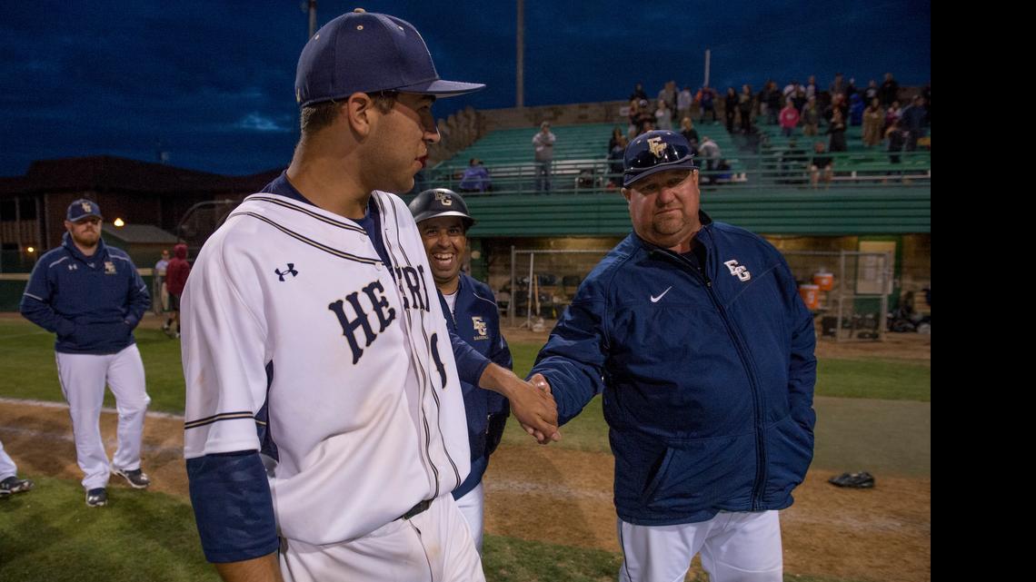 
Herd relief pitcher Dylan Carlson shakes hands with his father, Elk Grove coach Jeff Carlson, following the 2-0 victory in Game 2 of the Sac Joaquin Section Division I North championship between Elk Grove and Granite Bay at Sacramento City College on Friday, May 22, 2015, in Sacramento.
