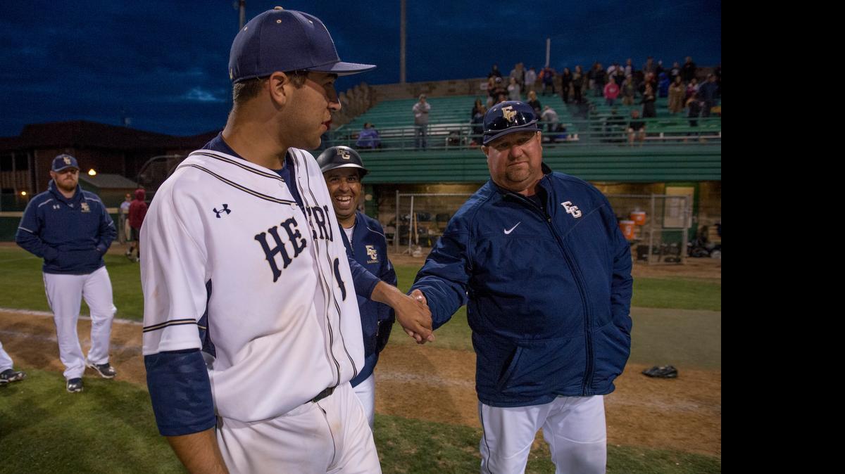 
Herd relief pitcher Dylan Carlson shakes hands with his father, Elk Grove coach Jeff Carlson, following the 2-0 victory in Game 2 of the Sac Joaquin Section Division I North championship between Elk Grove and Granite Bay at Sacramento City College on Friday, May 22, 2015, in Sacramento.
