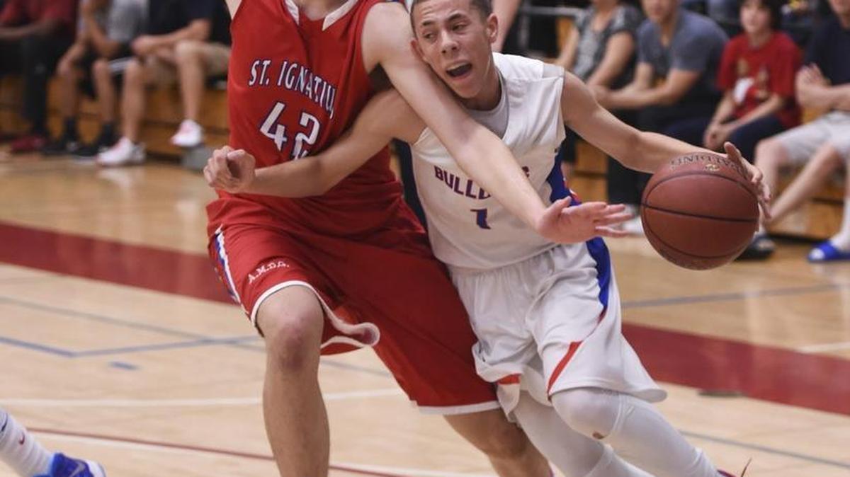 
Folsom High School guard Jordan Ford (1) is fouled by St. Ignatius Wild Cat's Arash Poorsina (42) as the Folsom High School Bulldogs basketball team host St. Ignatius Wildcats in the CIF Northern California playoff game, Saturday March 15, 2014. Folsom won the game 66-40. 
