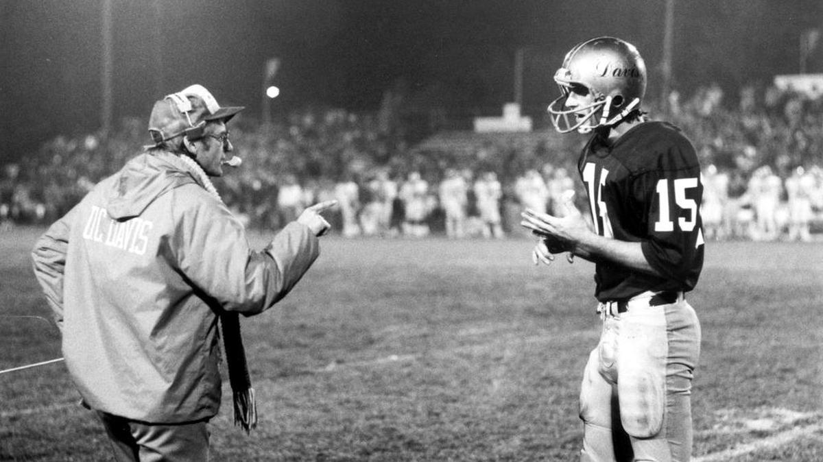 Legendary UC Davis football coach Jim Sochor addresses quarterback Ken O’Brien during a game in 1982.