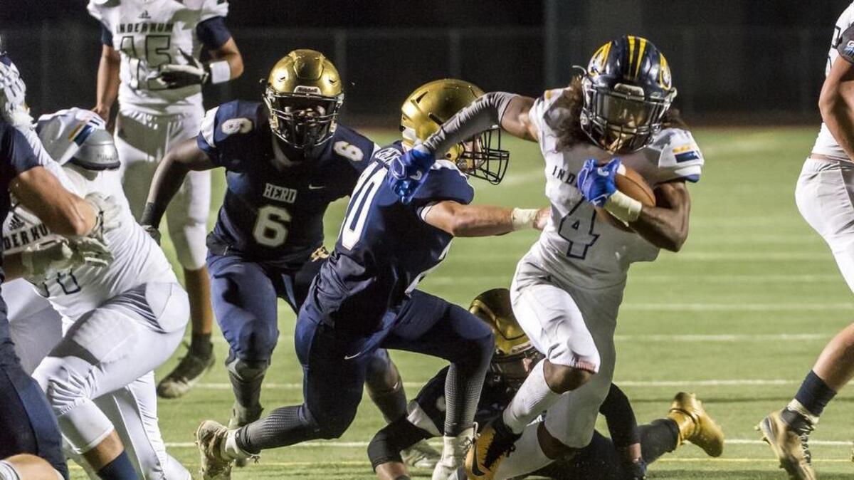 Inderkum Tigers Destynd Lewis (4) runs with the ball during the second quarter on Friday against Elk Grove.