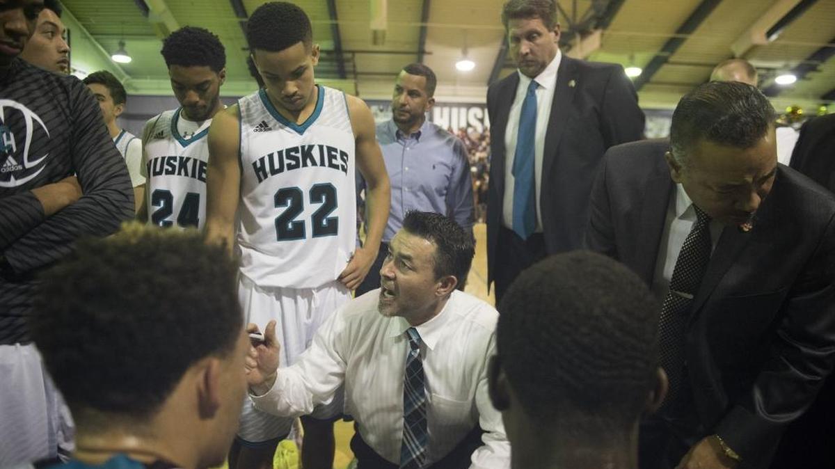 Sheldon High boys basketball coach Joey Rollins designs a play before the Huskies come out of a timeout late in the fourth quarter against Jesuit at Sheldon high school on Jan. 15, 2015.