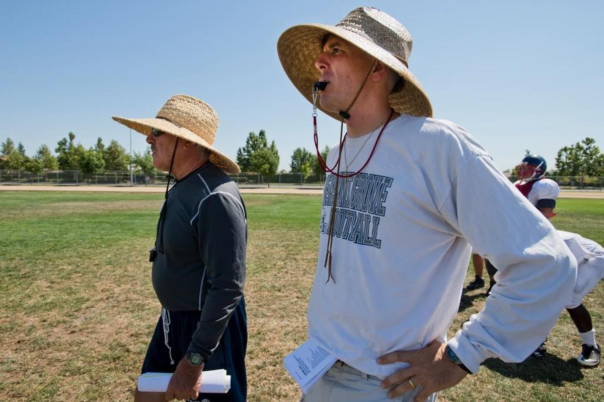 Coach Joe Cattolico, right, then with the Sheldon Huskies, walks with father and then-assistant coach Butch Cattolico, left, in 2013.