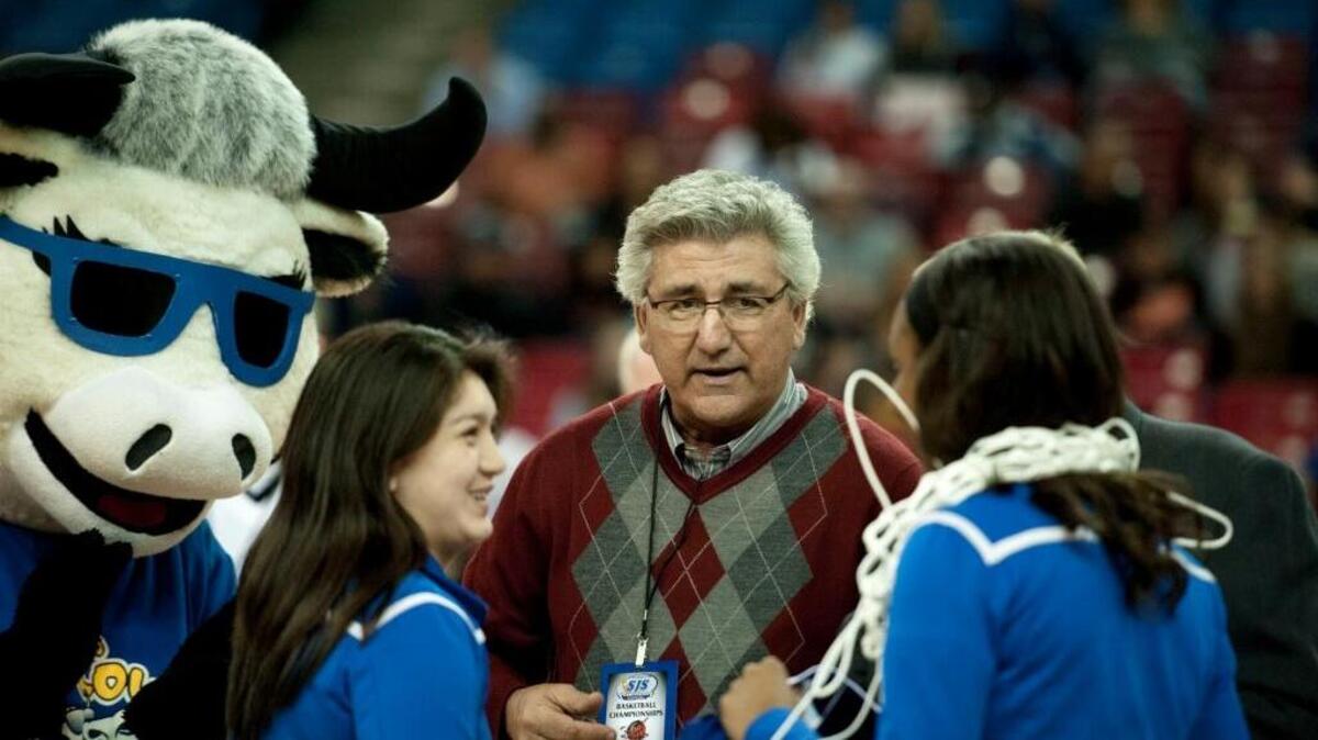 Sac-Joaquin Section commissioner Pete Saco hands out medals at the Division V girls basketball championship game at Sleep Train Arena on March 7, 2014.