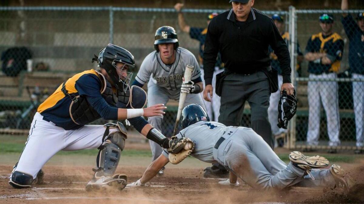 Elk Grove’s Aaron Wong is tagged out by Oak Ridge catcher Brendan Galbreath in the first inning Tuesday.