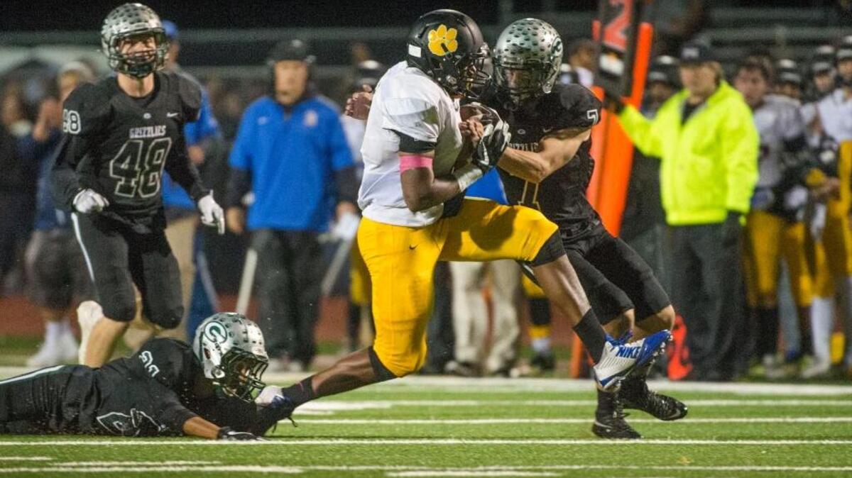 Del Campo Marshaun Hunter, center, runs for a first down while being tackled by Granite Bay’s Zach Grable (7) and Jaylen Latson (21) on Nov. 24, 2017. Hunter will play for the South team in the Optimist All-Star Football Classic on Saturday at Sacramento State.