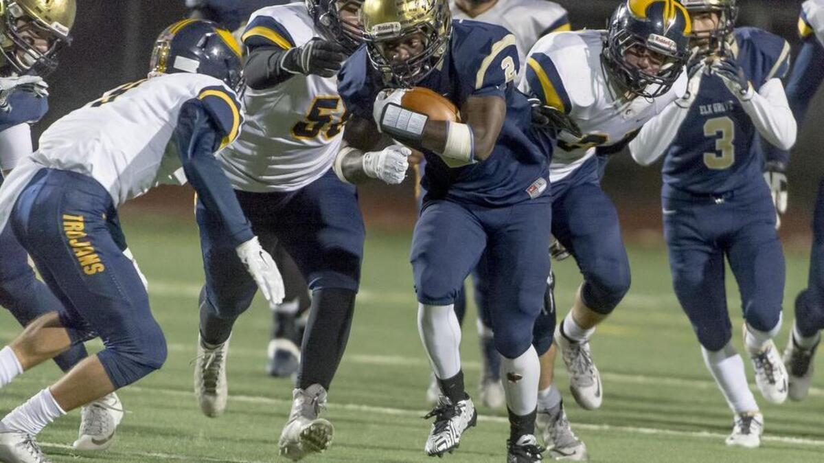Elk Grove’s Julius Fullah (2), runs with the ball during the third quarter of the Sac-Joaquin Section Division I semifinal football game at Elk Grove High School on Friday, Nov. 27, 2015.