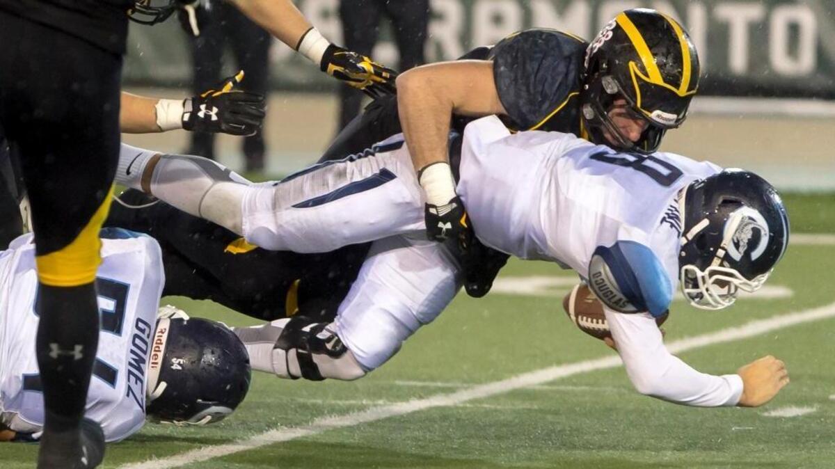 Del Oro’s John Spencer (11), sacks Camarillo quarterback Jake Constantine during the CIF State Division II-AA championship football game at Sacramento State, Friday Dec 18, 2015. Wet weather – and TV coverage – contributed to low attendance for the games the concluded Saturday, Dec. 19.