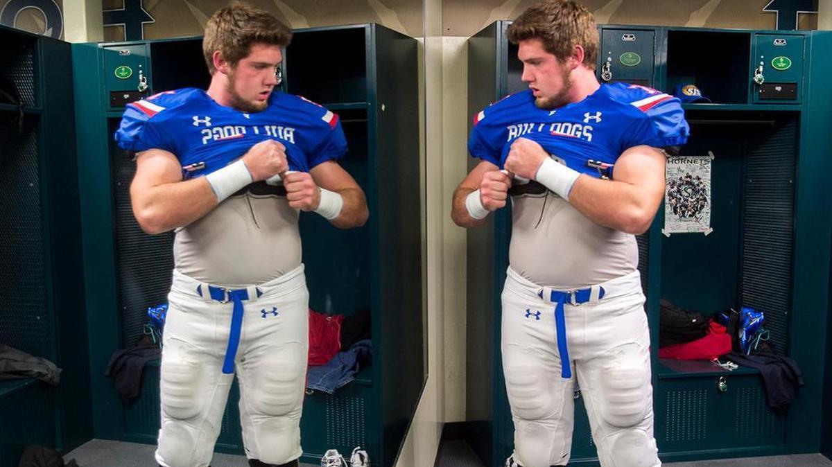 
Folsom’s Jonah Williams gets his gear on in the locker room before the Bulldogs play Grant in the CIF Northern California Regional Division I championship game at Sacramento State on Dec. 12, 2014. 
