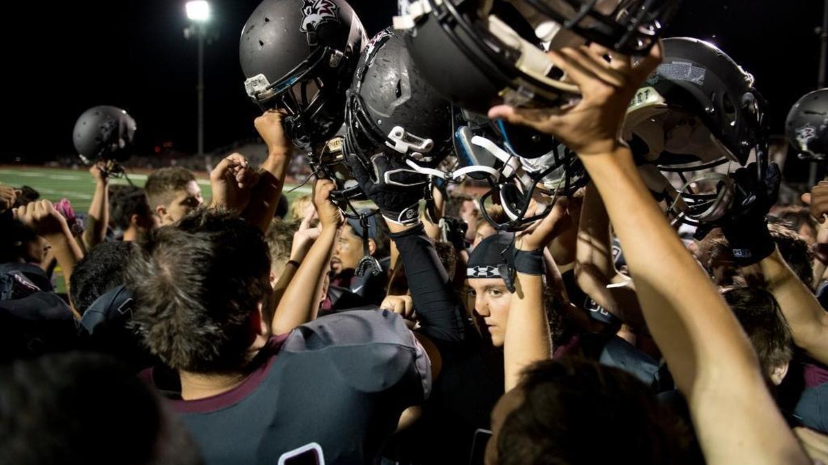 The Woodcreek football team celebrates a victory over Ponderosa in 2014. On Friday against Nevada Union, Woodcreek quarterback Carter Krupp scrambled and unloaded a pass into the end zone, where it was tipped, and Peyton Allen snatched it with no time left for a 54-53 triumph.