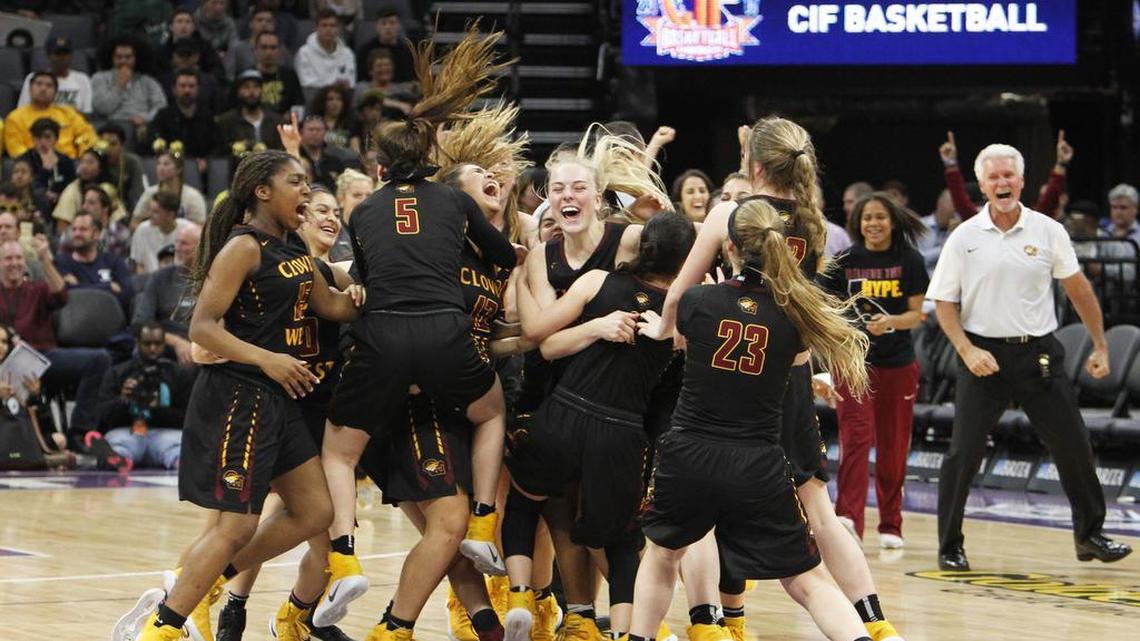 Clovis West players celebrate their win over Archbishop Mitty in the girls CIF Open Division high school basketball championship game Saturday in Sacramento. Clovis West won 44-40.