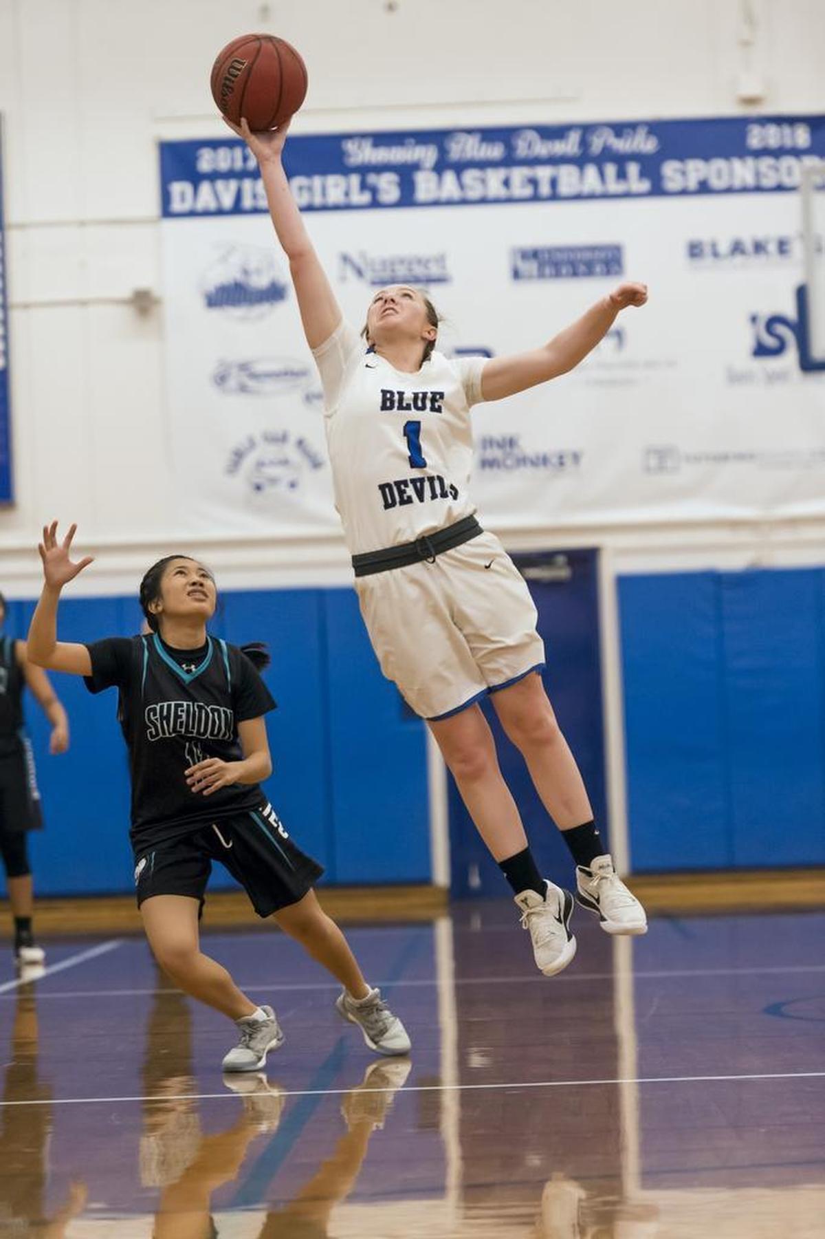 Davis High School Lady Blue Devils Kelsey Forrester (1) intercepts a pass intended for Sheldon Huskies Jordan Manuel (11) as the Davis High School girls basketball team host the Sheldon Huskies on Wednesday.