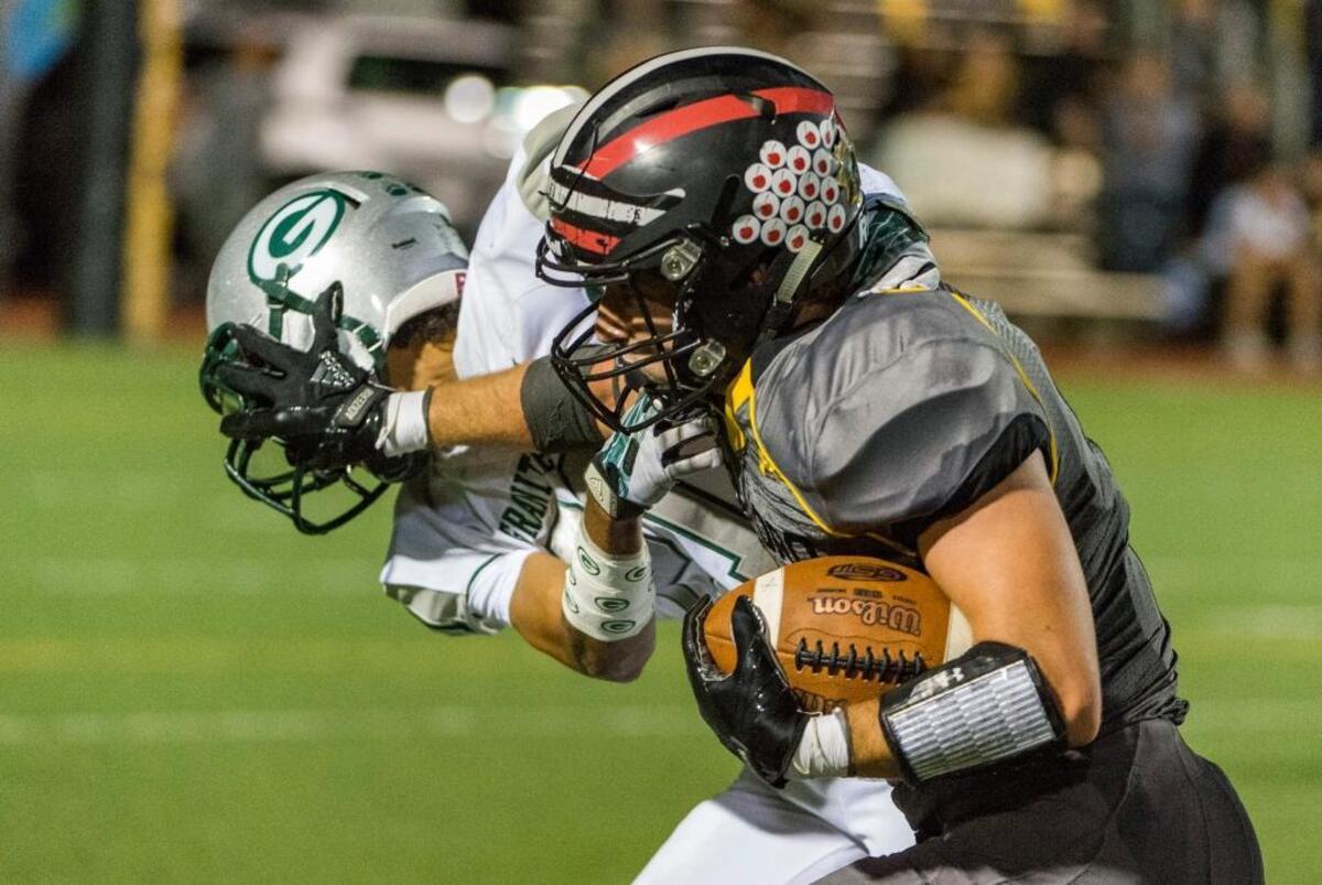 Del Oro’s Brice Edwards. right, stiff arms Granite Bay’s Jaylen Latson on Sept. 22.