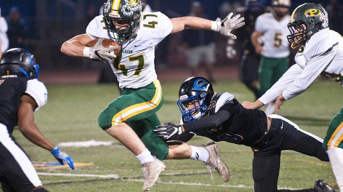 Placer junior Louis Fudge evades the Crenshaw defense during the CIF State Division IV-AA championship game at Crenshaw High School in Los Angeles on Saturday.