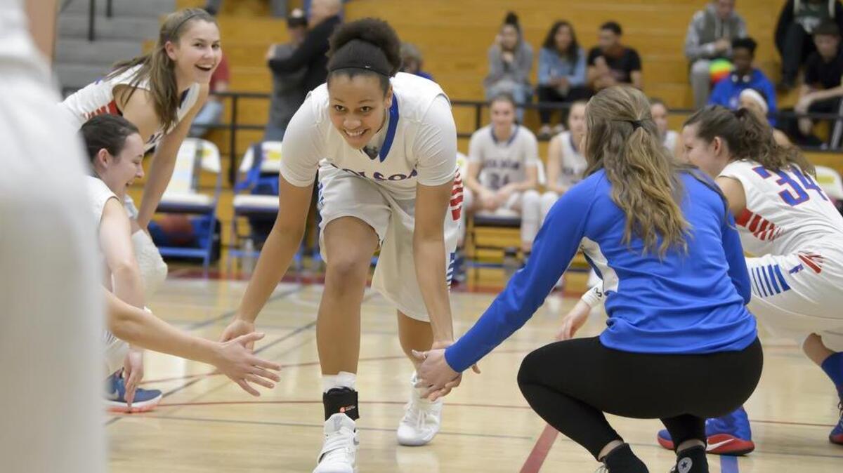 Folsom Bulldogs varsity girls basketball player, McKenzie Forbes, is greeted by her team as they host the Woodcreek Timberwolves, Friday Jan 20, 2017.