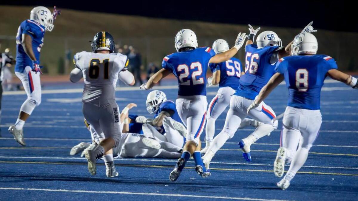 The Folsom High School Bulldogs defense reacts to stopping the point after attempt by Oak Ridge Trojans that would give them a 17-16 victory during the fourth quarter as the Folsom High School Bulldogs varsity football team host the Oak Ridge High School Trojans, Friday Nov 4, 2016.