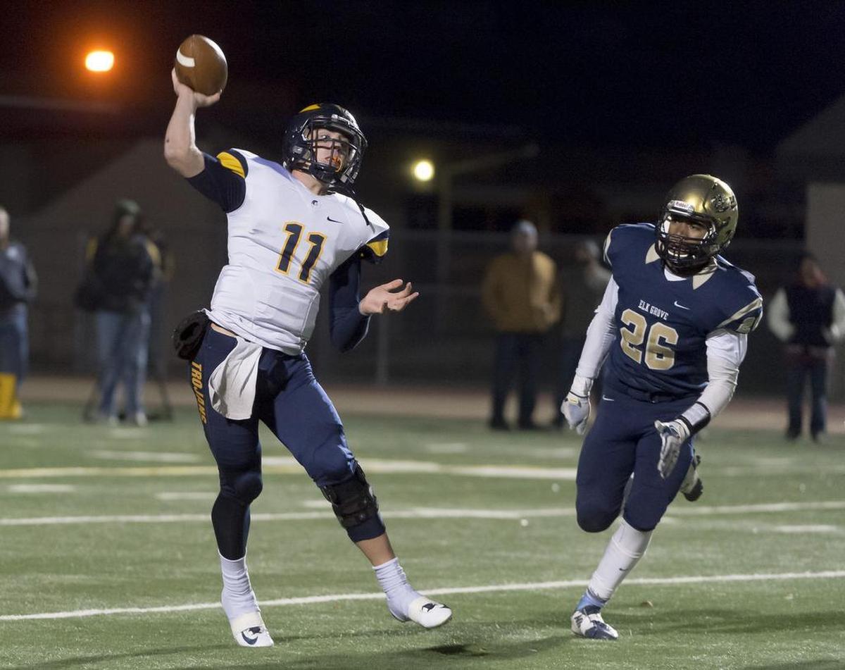 Oak Ridge Trojans quarterback Ian Book passes the ball during the third quarter of the CIF Sac-Joaquin Section Division I semifinal football game at Elk Grove High School on Friday, Nov. 27, 2015.