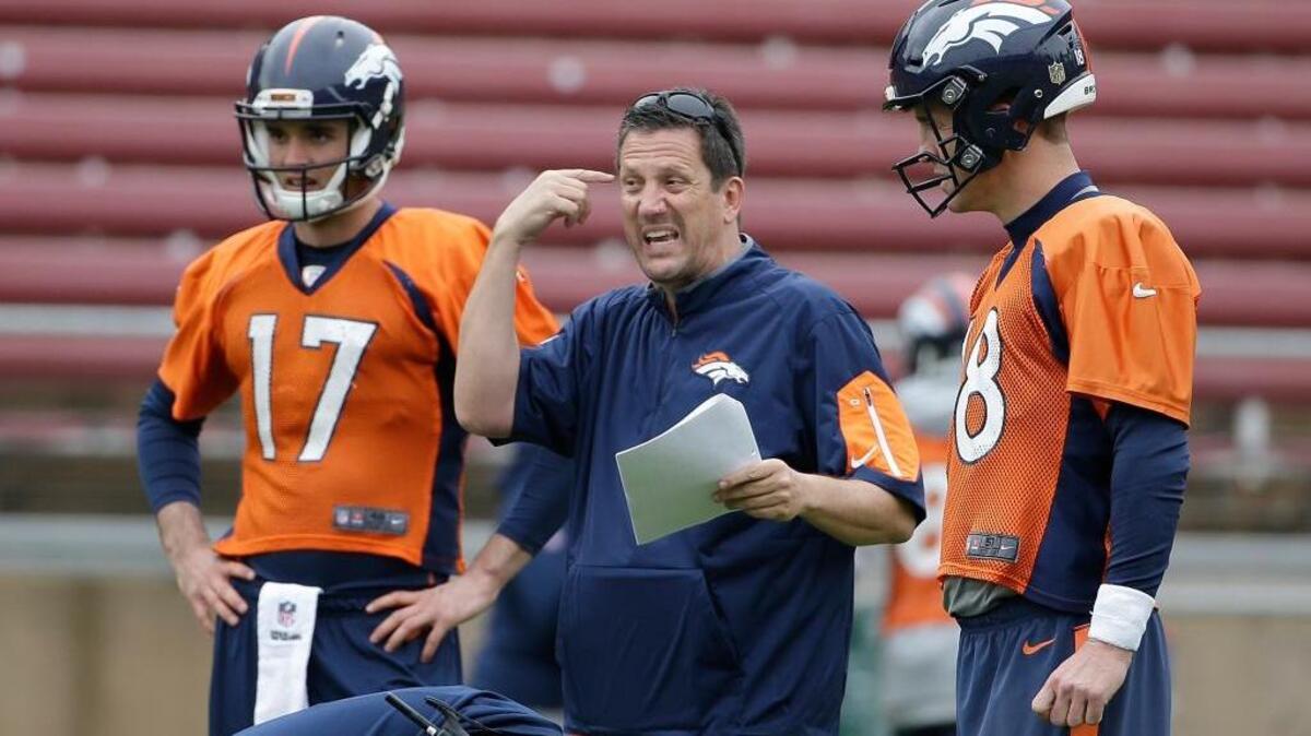 Denver Broncos quarterbacks coach Greg Knapp, center, talks with starter Peyton Manning, right, and backup Brock Osweiler during practice for Super Bowl 50 on Wednesday, Feb. 3, 2016, in Stanford, Calif.