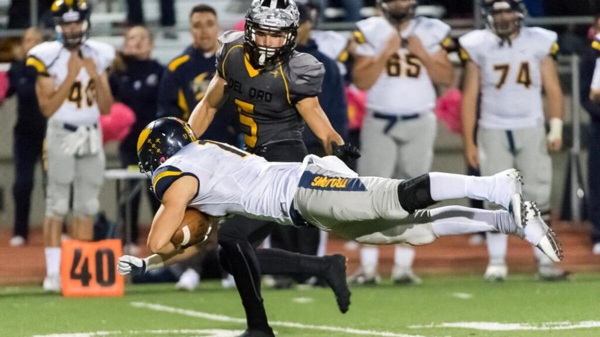Oak Ridge’s Austin Eastman (17), dives for yardage during the fourth quarter during a high school football game against Del Oro on Friday Oct. 21, 2016 in Loomis.