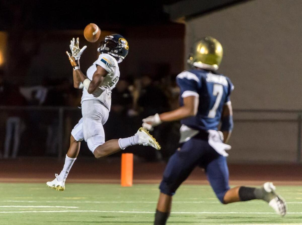 Inderkum wide receiver Isaah Crocker, left, catches a touchdown against Elk Grove last season. Crocker, known for his speed, was a focal point on the 11-1 Tigers team.