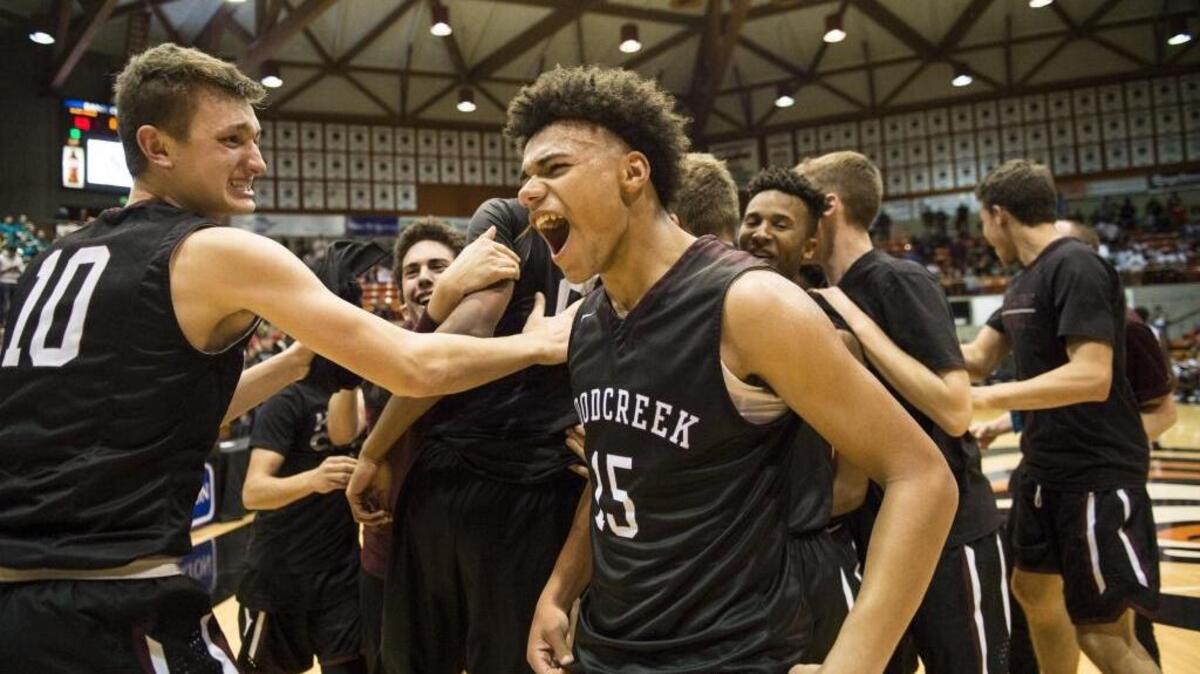 Woodcreek Timberwolves Jackson Hughes (15) and forward Will Larshin (10) celebrate after winning the Division I Sac-Joaquin Section basketball championship game between the Sheldon Huskies and the Woodcreek Timberwolves on March 4. The two teams face each other again Saturday at the CIF Northern California Regional finals.