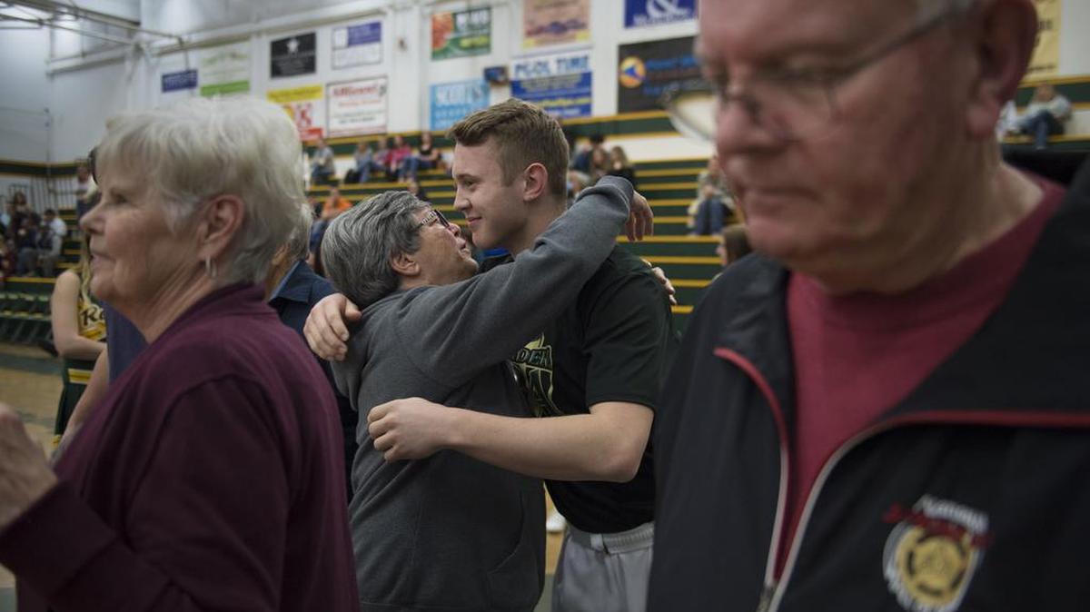 Bonnie Lyon embraces her grandson, Rio Americano's Matt Lyon before the final home game against Christian Brothers on Tuesday night, February 9, 2016 at Rio Americano High School in Sacramento.