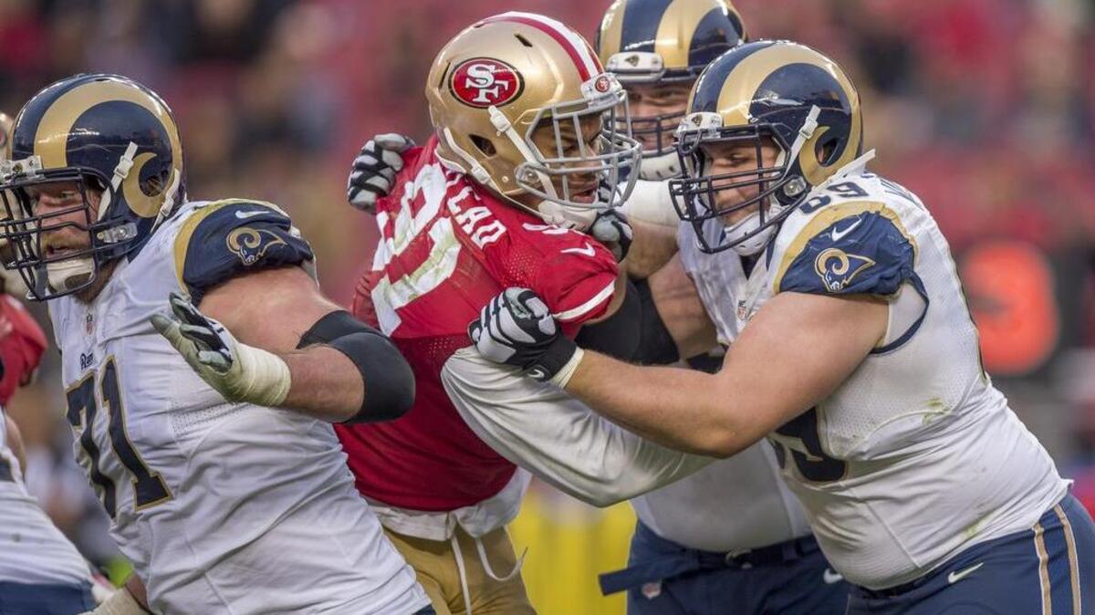 San Francisco 49ers defensive end Arik Armstead (91) is double-teamed as he rushes the quarterback in the fourth quarter in the NFL game between the San Francisco 49ers and St. Louis Rams on Sunday, January 3, 2016 at AT&T Park in Santa Clara.