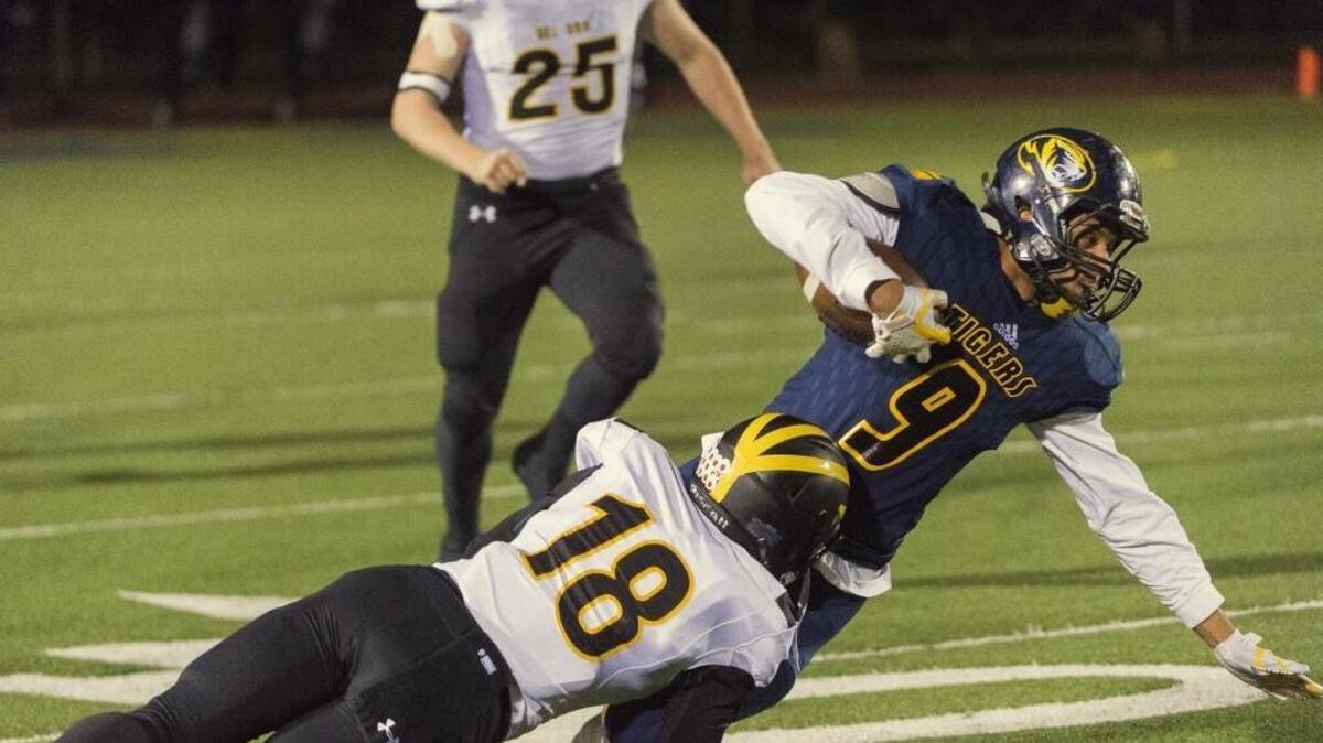 Del Oro Golden Eagles Dante Pericin (18), tackles Inderkum Tigers Preston Doyle (9), during the second quarter as the Inderkum Tigers football team host the Del Oro Golden Eagles in the Sac-Joaquin Section Division II second round playoff game, Friday, Nov. 17, 2017.