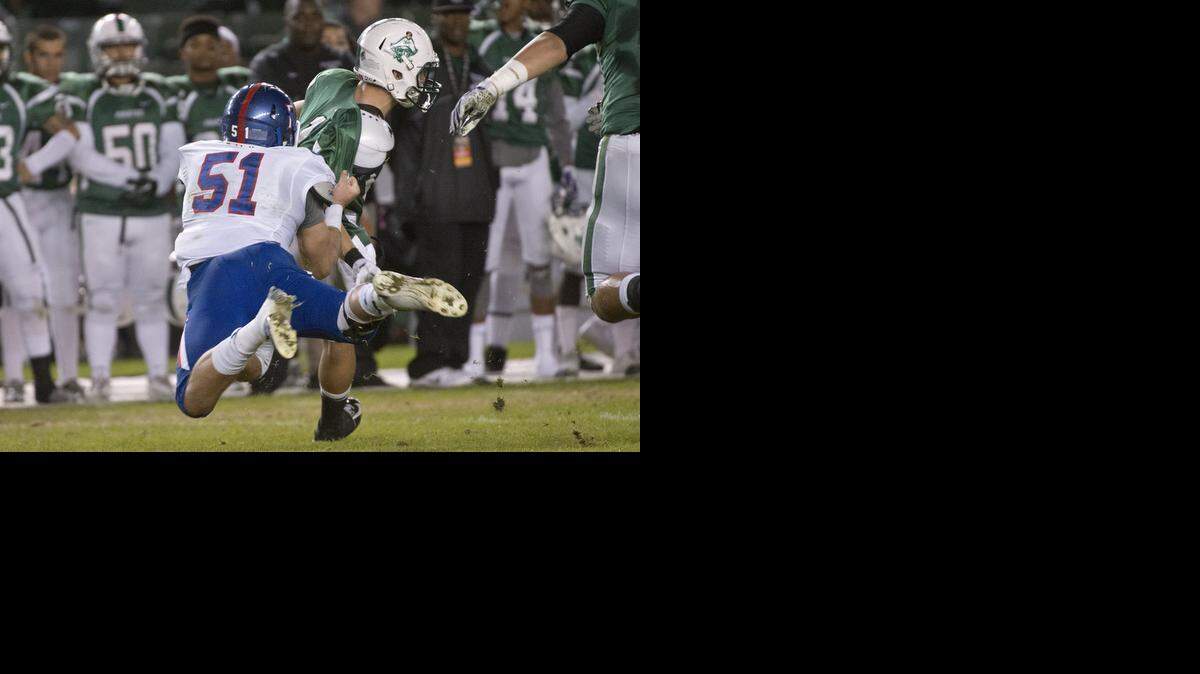 
Bulldogs Sam Whitney (51) makes a tackle during the CIF Division I state championship game between the Folsom High School Bulldogs and the Oceanside High School Pirates at the StubHub Center in Carson on Dec. 19, 2014.
