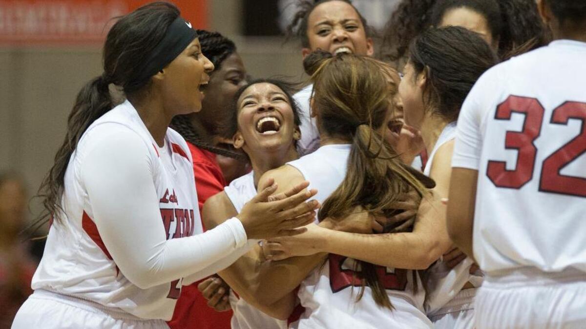 Members of the Antelope High basketball team celebrate following their 68-60 victory over Sacramento High in the Sac-Joaquin Section Girls Division II semifinal playoff game at Pacific’s Alex G. Spanos Center on Tuesday, March, 1, 2016 in Stockton.
