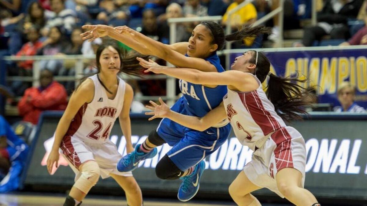Serra Cavaliers guard Briana Johnson (2) passes as she's double teamed by McClatchy Lions Kelsey Wong (3) and guard Kristi Wong (24) in the second quarter on Friday night, March 27, 2015 in the girls Div 1 State Championship game between the McClatchy Lions and Serra Cavaliers at Haas Pavilion in Berkeley, California