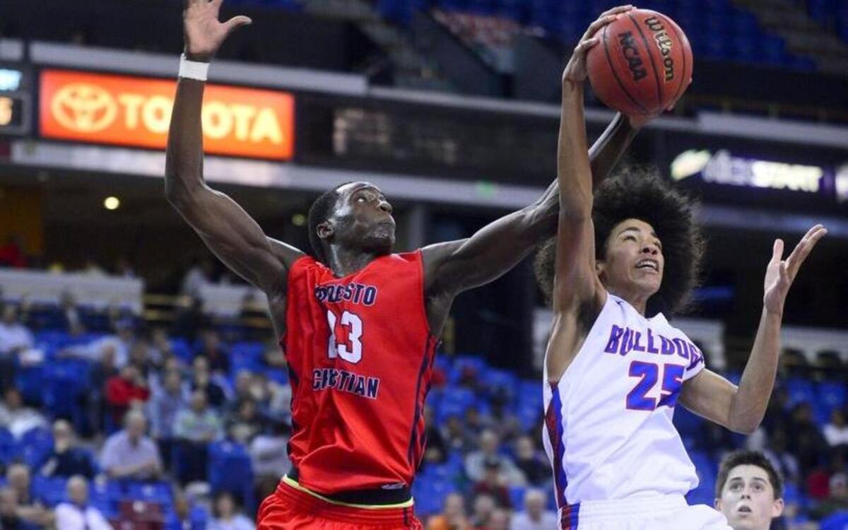 Modesto Christian forward Robinson Idehen (23) fights for a rebound with Folsom's Mason Forbes (25) during the CIF San-Joaquin Section Division I final on Saturday, March 5, 2016 at Sleep Train Arena in Sacramento.