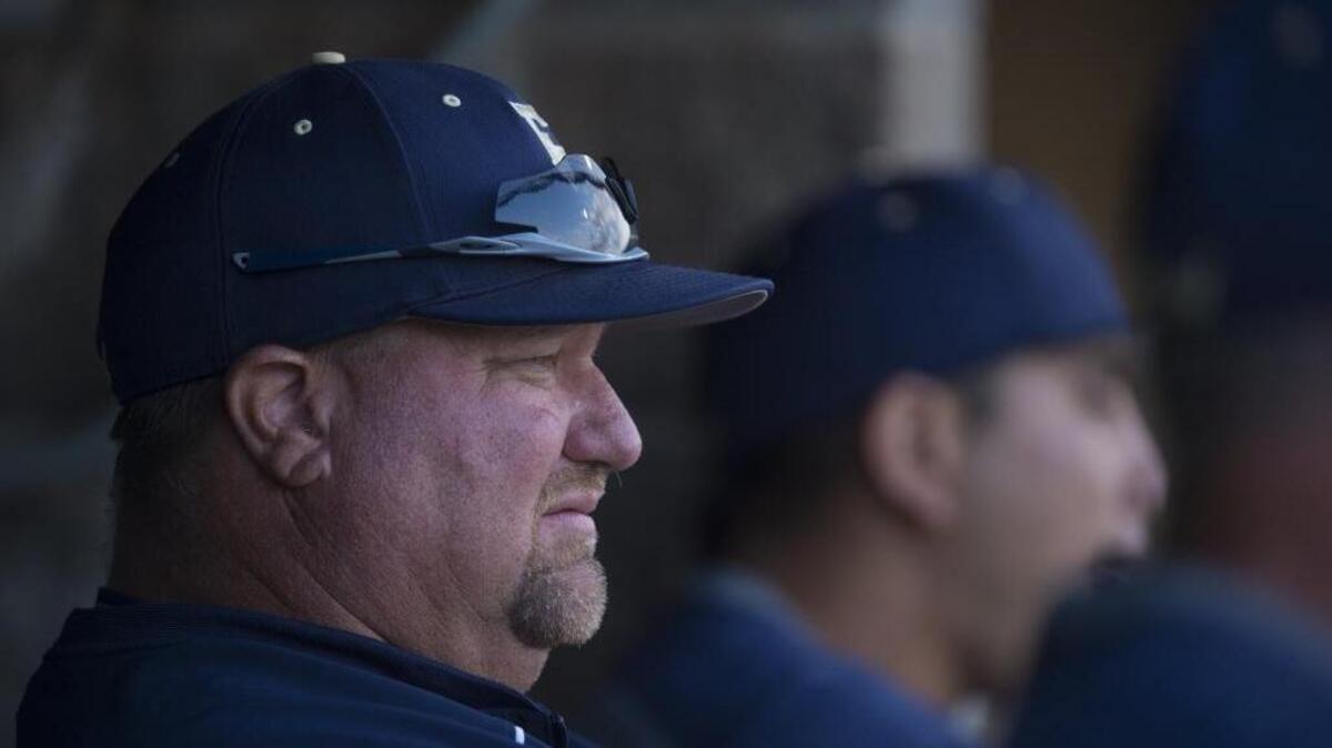 Elk Grove coach Jeff Carlson watches from the dugout as the Thundering Herd plays Granite Bay at Sacramento City College on May 22, 2015.