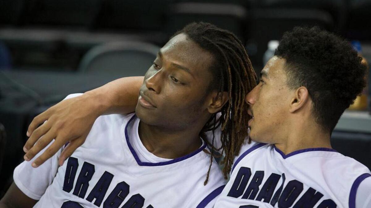 Sacramento High School Dragons Solomon Young, left, and Christian Terrell sit on the bench following their 54-40 loss to the Archbishop Mitty during the NorCal Boys Division II championship at Sleep Train Arena on Saturday, March 21, 2015, in Sacramento, Calif. Sacramento lost 54-40.