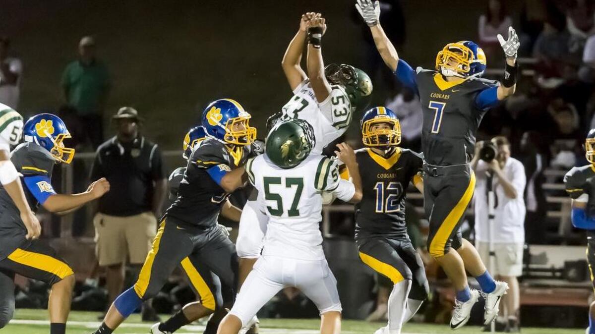 Players fight for the insides kick by the Del Campo Cougar's which they recovered during the fourth quarter as the Del Campo Cougars host the Monterey Trail Mustangs Friday Sept. 2, 2016.