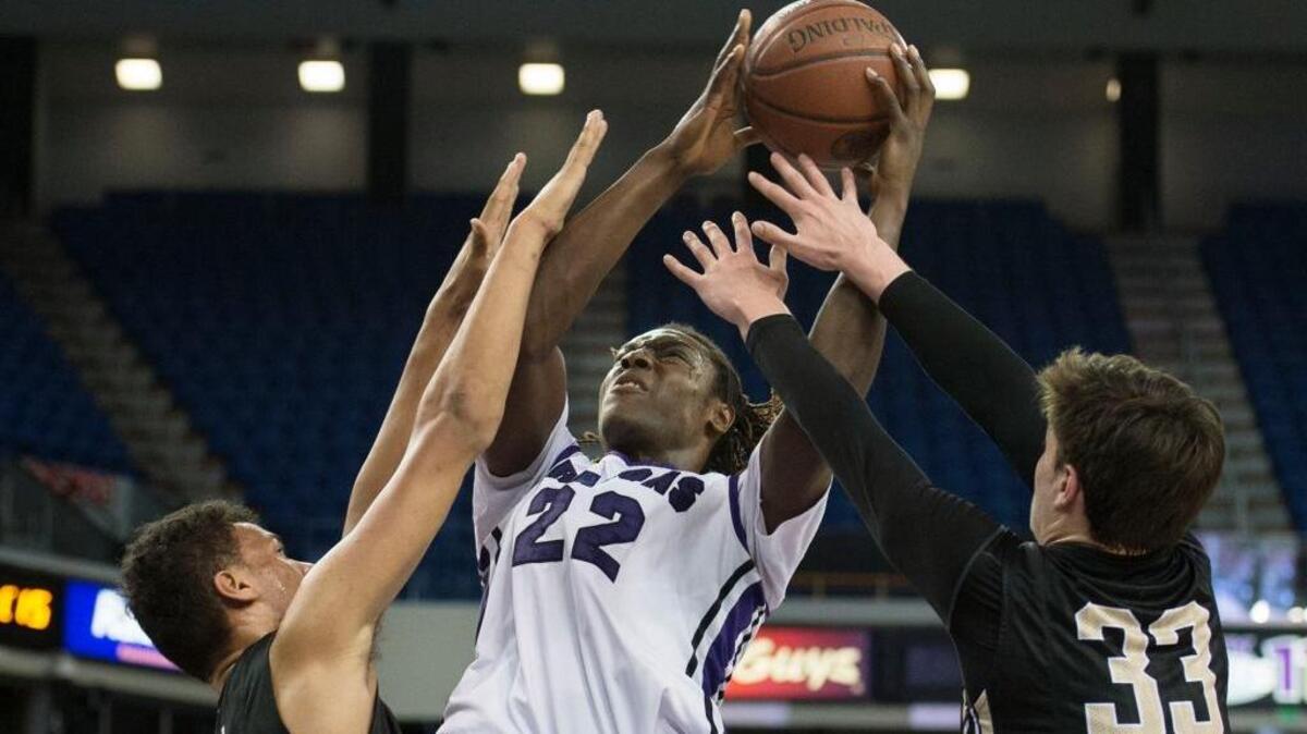 Monarchs Ben Kone (34) and Sebastian Much (33) defend Sacramento’s Solomon Young (22) during the NorCal Boys Division II championship at Sleep Train Arena on Saturday, March 21, 2015.