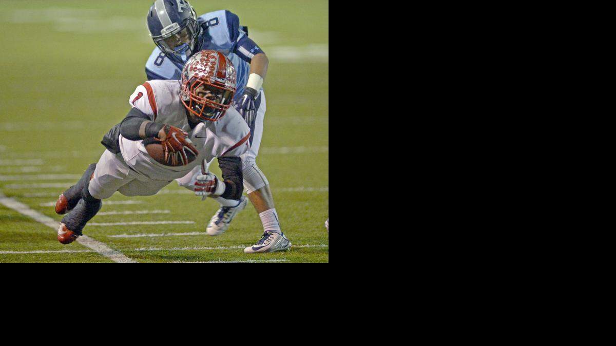 Antelope running back Mister Harriel dives in an effort to secure a first down as Downey’s Eddie Preciado pursues. Downey beat Antelope 20-19.<252><137>Antelope running back Mister Harriel dives toward the first down during a Division II CIF Playoff game between Downey and Antelope at Chuck Hughes Stadium at Downey High School on November 14th.<252><137>