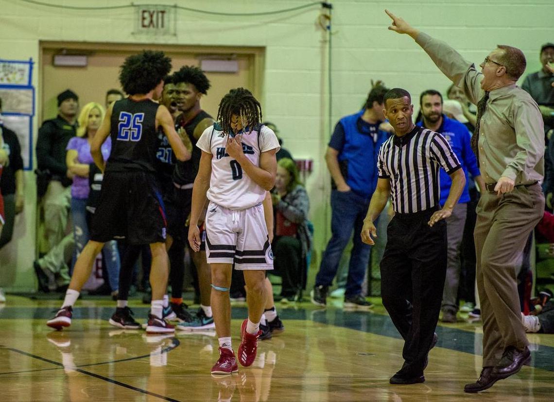 Folsom Bulldogs Martis Johnson (13) is bumped by teammate Mason Forbes (C) (25) after making a three point shot as he was fouled by Sheldon Huskies guard Dale Currie (0) to tie the game late in the fourth quarter.