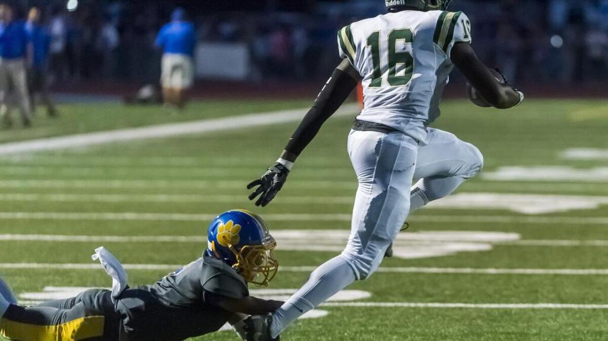 Monterey Trail Mustangs Bishop Brown (16) runs with the ball after his interception during the first quarter as the Del Campo Cougars host the Monterey Trail Mustangs Friday Sept. 2, 2016.