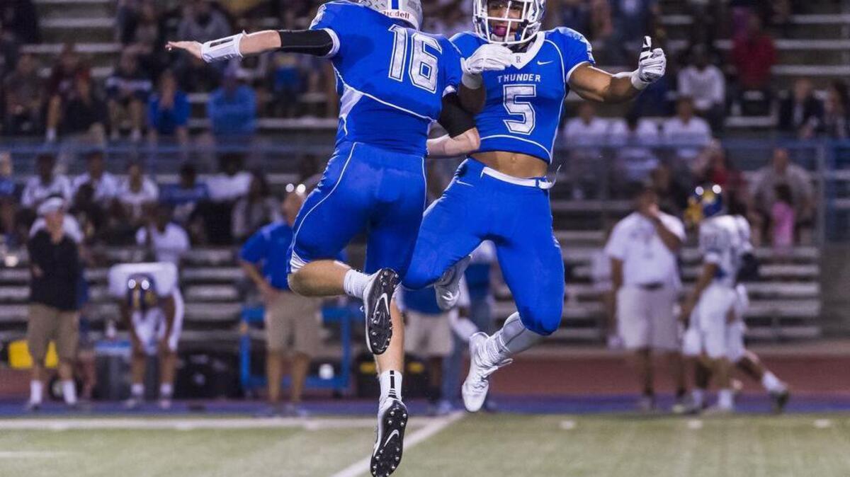 
Rocklin's William Floyd (16) greets Rocklin's Evyn Holtz (5) after his kickoff return for a touchdown making the score 27-14 after the point after attempt was good.
