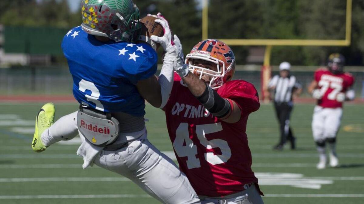 River Valley’s Dante Love, left, catches the ball in the endzone as Elk Grove’s Michael McKee does his best to break up the play in the first half of the Optimist All-Stars football game at Jesuit High School in Carmichael, Calif. on June 18, 2016.