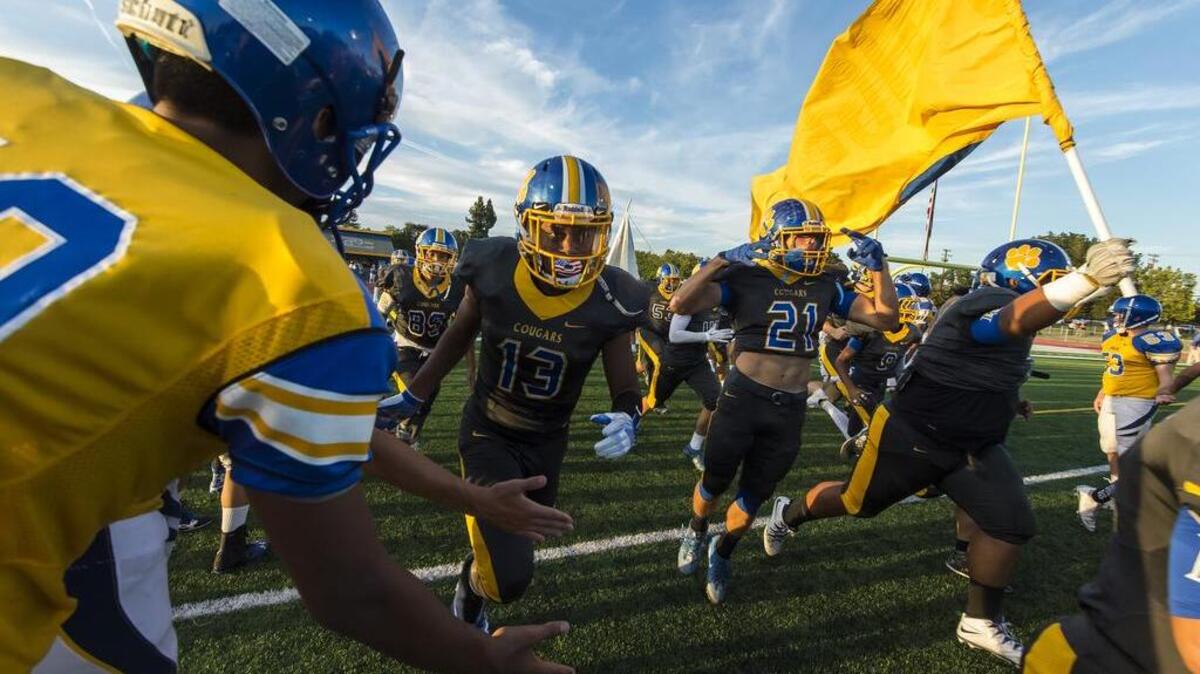 The Del Campo Cougas football team takes the field as they host the Monterey Trail Mustangs Friday Sept. 2, 2016.