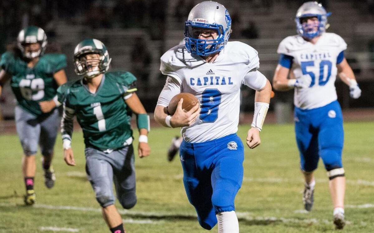 
Capital Christian quarterback, Jacob Norville (8), runs for a touchdown in the first quarter as the Dixon Rams host the Capital Christian Cougars on Friday, October 16, 2015. 
