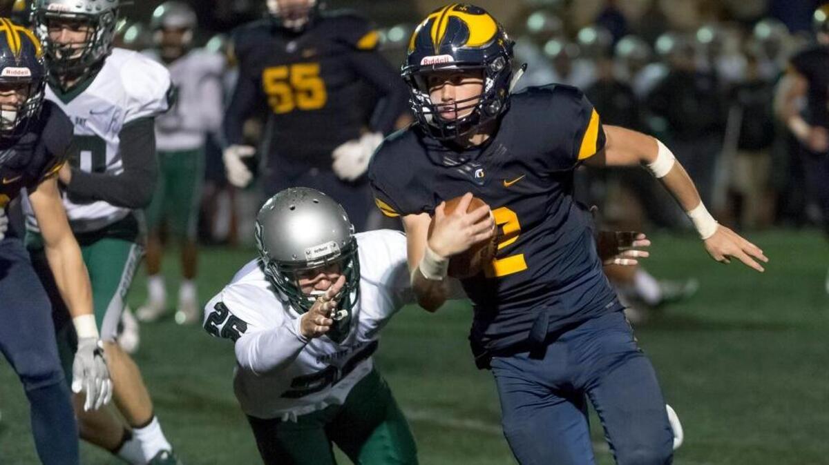 Marco Baldacchino, right, helped Oak Ridge run away from Granite Bay during last year’s matchup. On Friday, the quarterback led the Trojans to another victory over the Grizzlies with a fourth-quarter touchdown pass and a scoring run in overtime.