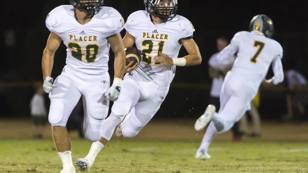 Placer High School Hillmen's Owen Scott (21), runs with the ball during the first quarter as the Bear River Bruins host the Placer Hillmen, Friday October 23, 2015.