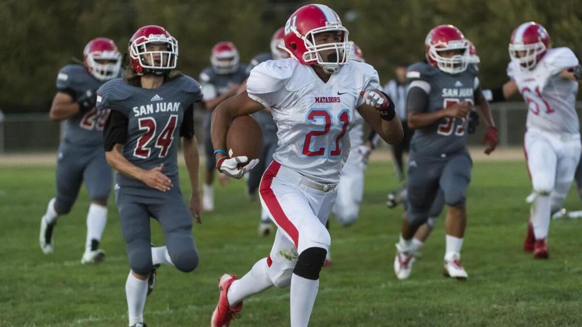 Mira Loma Matadors Isaiah Mull (21) runs for a touchdown making the score 14-0 after the point after attempt was good during the first quarter as the San Juan Spartans host the Mira Loma Matadors, Friday Sept. 16, 2016.