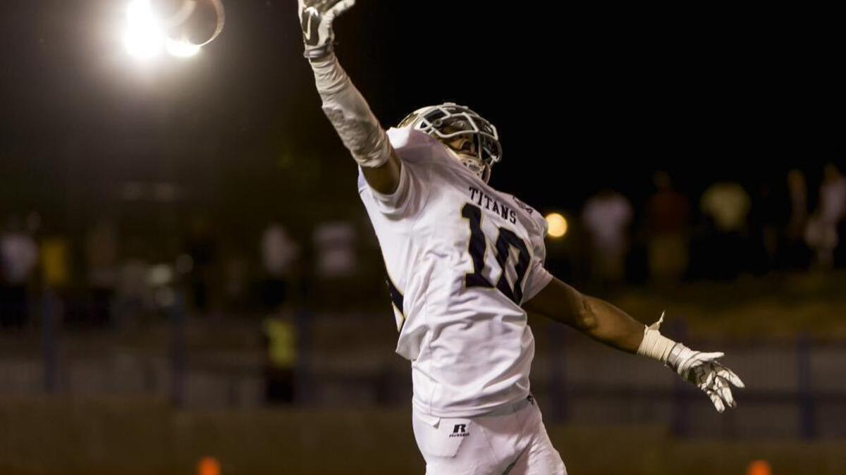 
The ball sails past the fingers of Burbank Titan's receiver Erik Brown.

